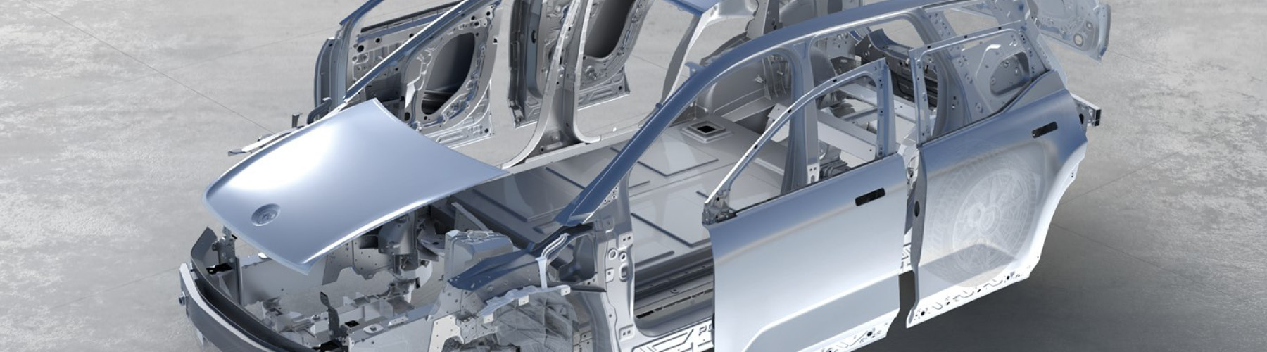 Grey vehicle in a parking garage highlighting the body panels