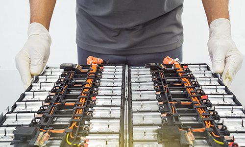 Rear view of grey vehicle taillights on with fog in background