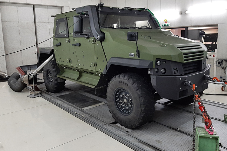 Rear view of grey vehicle taillights on with fog in background