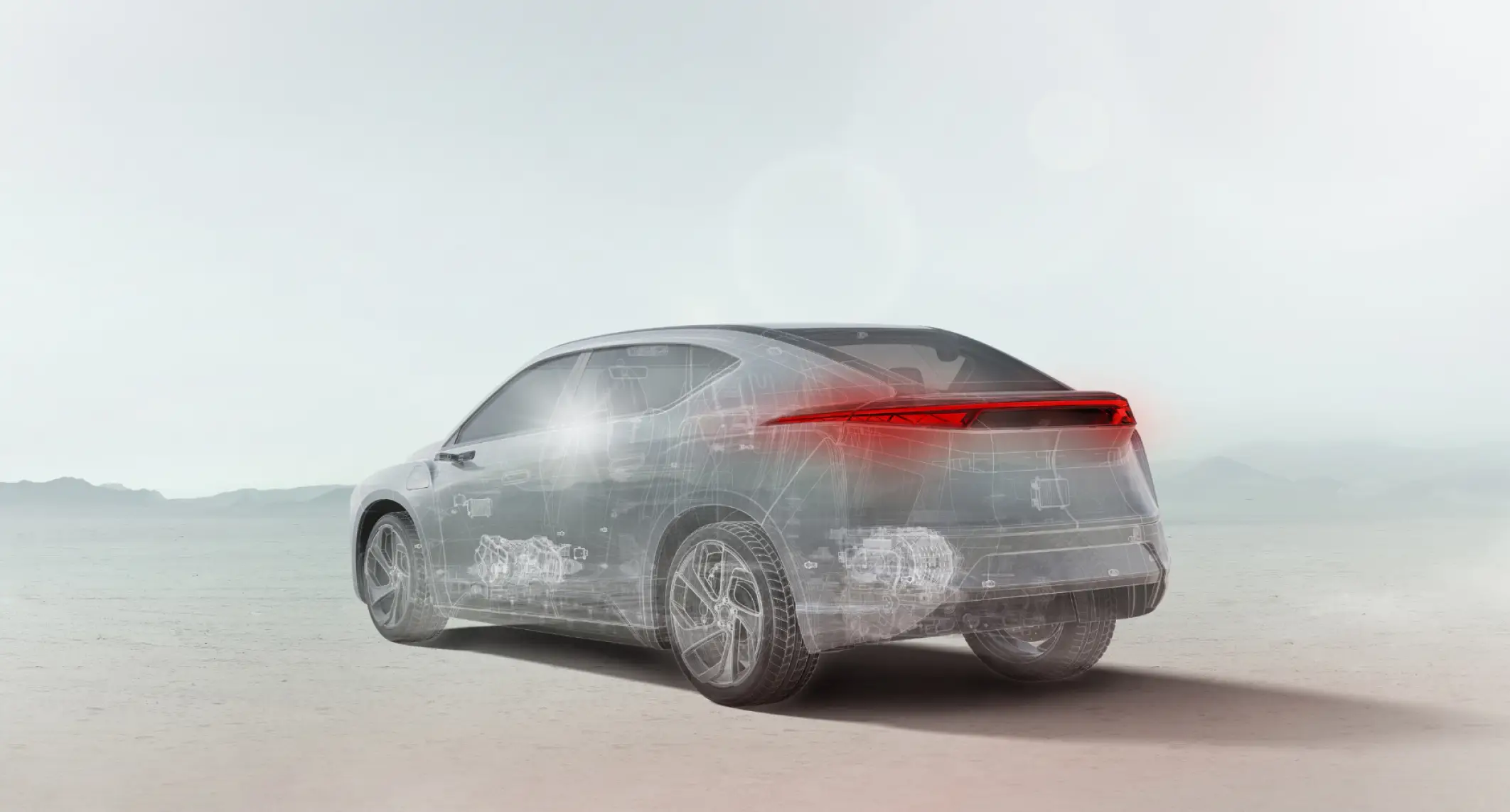 A transparent car concept, with internal components faintly visible and red glowing taillights, is seen from the rear on a light, desolate landscape.