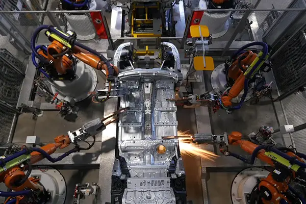 Robotic arms welding and assembling a car body on an automotive production line